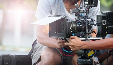 Two people operating a motion picture camera